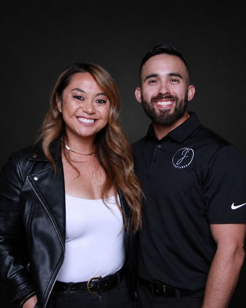 Jake and Janelle standing together against a dark backdrop